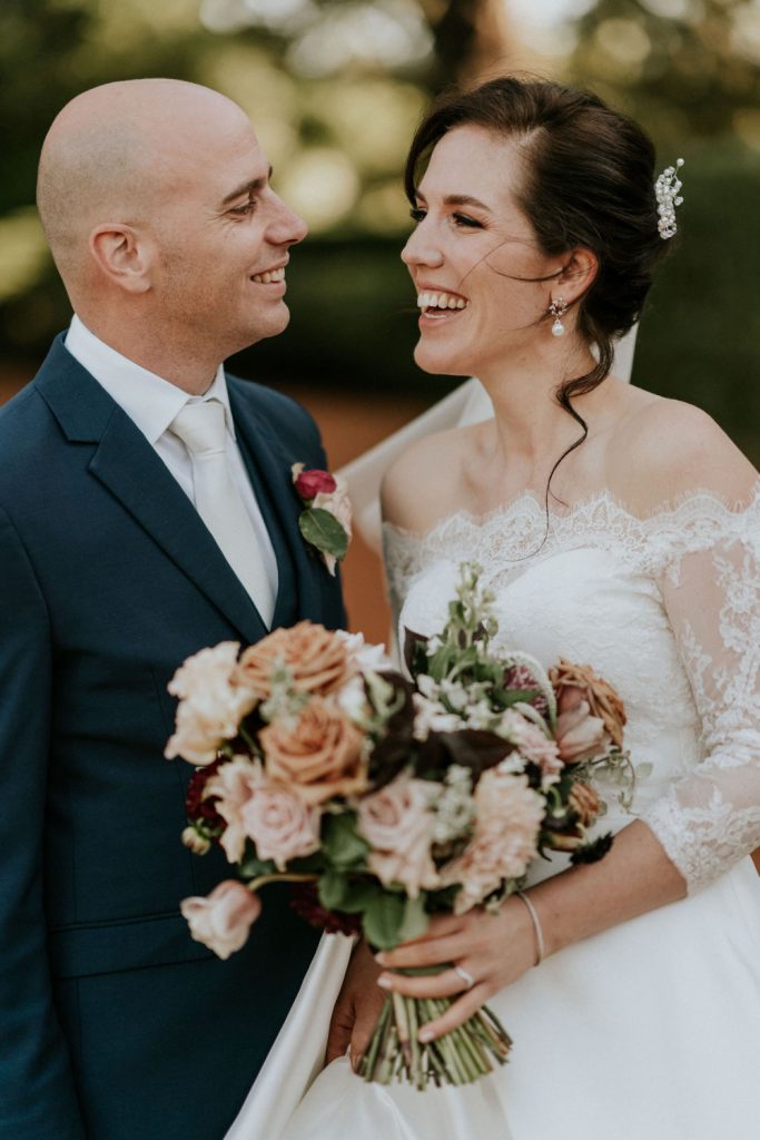 Bride and groom smiling together on their wedding day