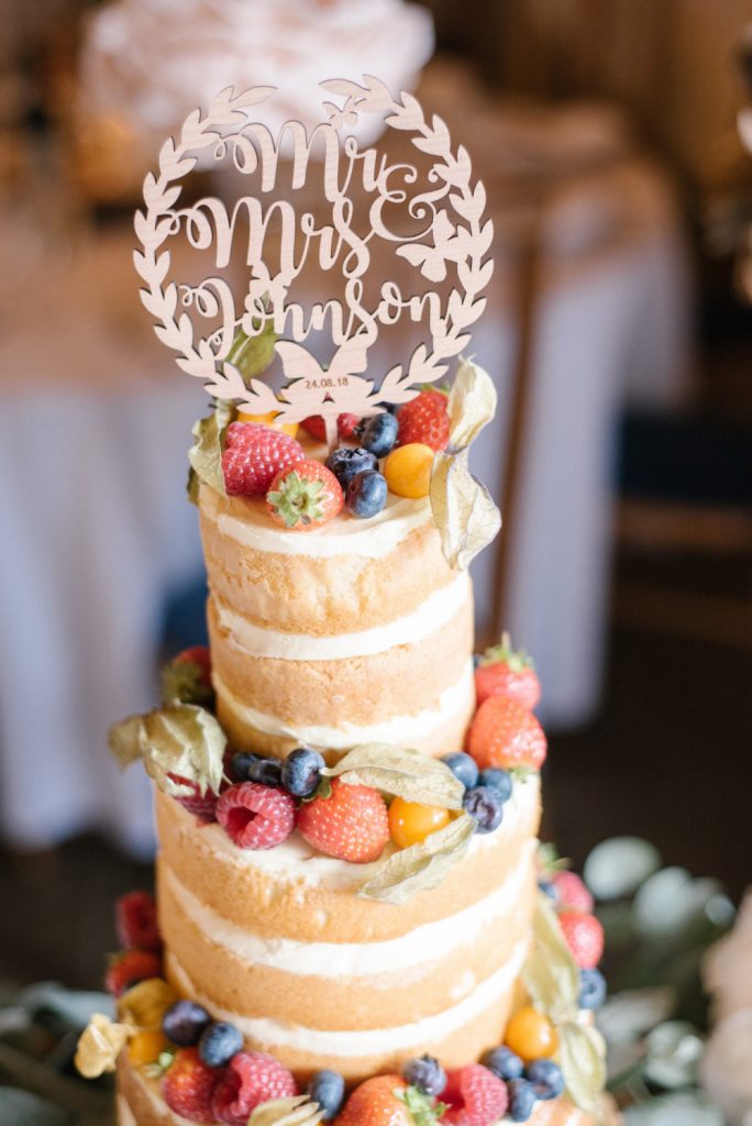 Tall layered sponge wedding cake with fruits