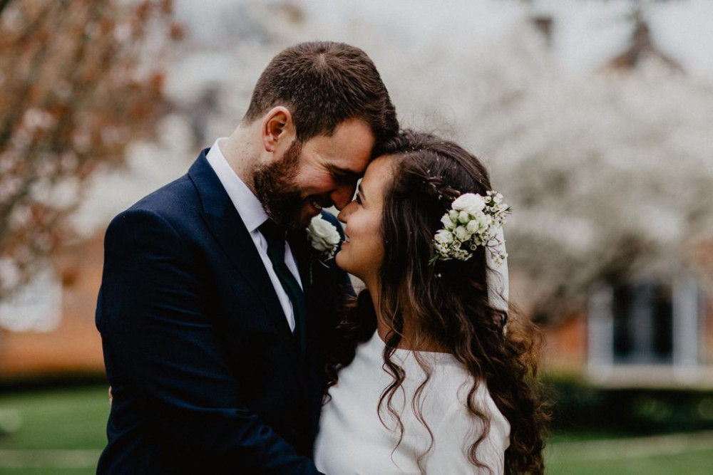 Bride and groom embrace on wedding day