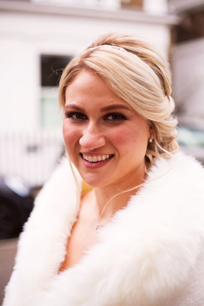 modern-urban-bride-with-romantic-low-bun-and-white-faux-fur-stole