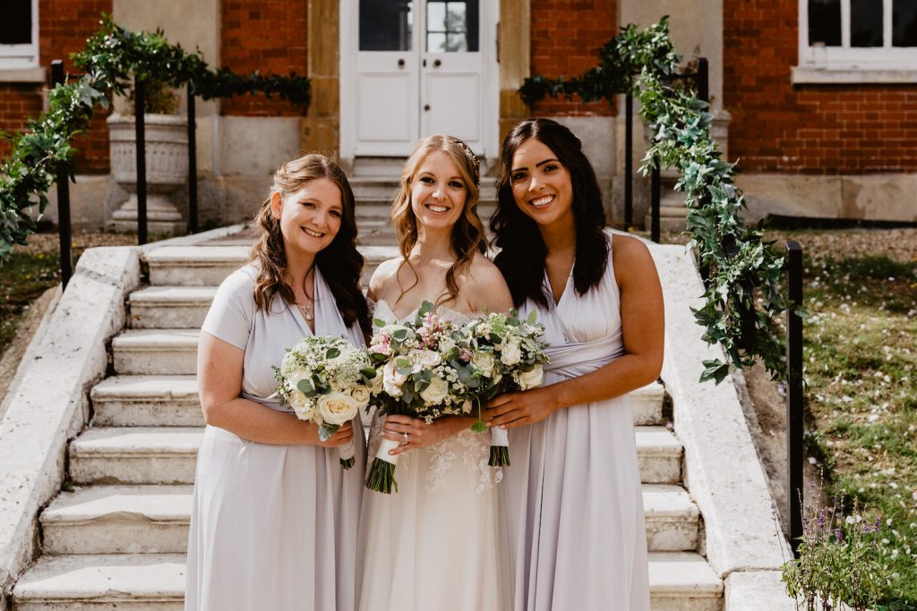 bridesmaids in silver grey dresses with soft waves